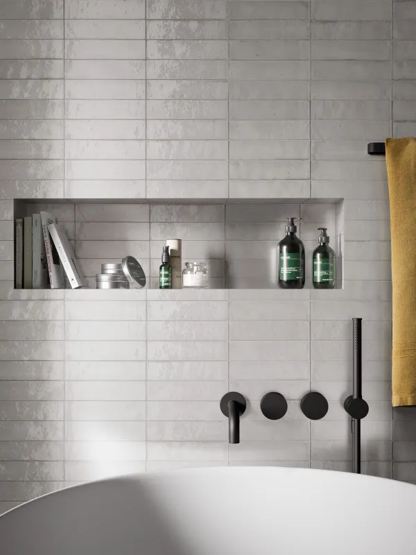 Baño con azulejos efecto barro en tonos neutros, colección Lume de Marazzi