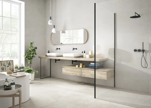 Baño con azulejos efecto cemento en tonos neutros, colección Clunia de Durstone