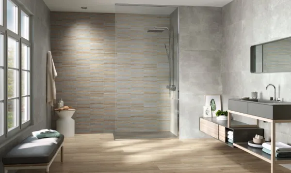 Baño con azulejos efecto cemento en tonos neutros, colección Evo de Fanal