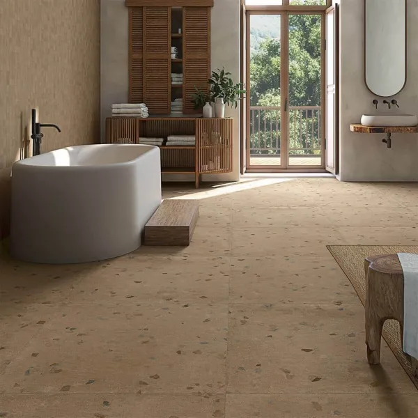 Baño con azulejos efecto terrazo en tonos cálidos, colección Bloom de Vives