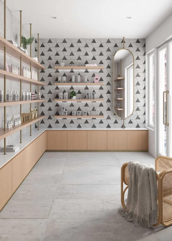 Comercio con azulejos efecto cemento en tonos neutros, colección Werkbund de Land