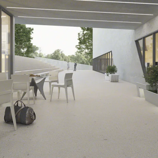 Exterior con azulejos efecto terrazo en tonos neutros, colección Pangea de Vives