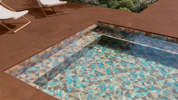 Piscina con azulejos efecto cemento, colección Acuarela de Exagres