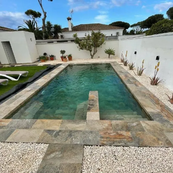 Piscina con azulejos efecto piedra en tonos fríos, colección Aspen de Mikonos