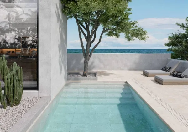 Piscina con azulejos efecto piedra en tonos fríos, colección Salem de Mayor